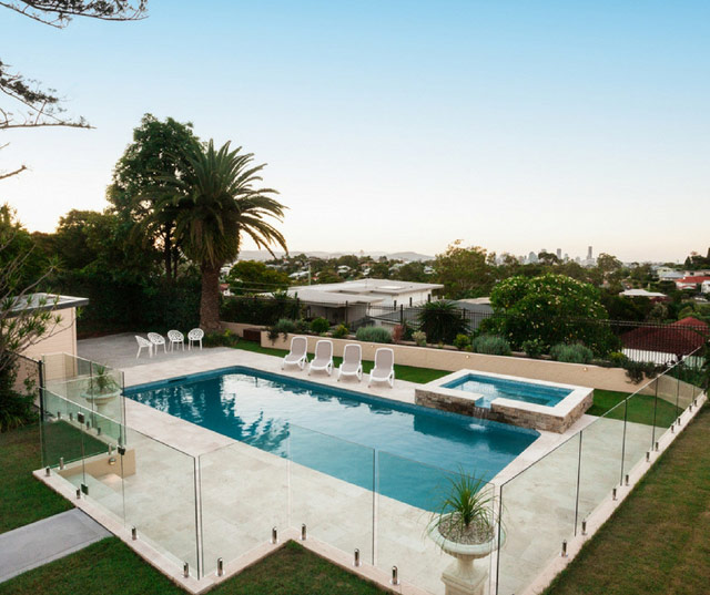 pool and hot tub with glass fence